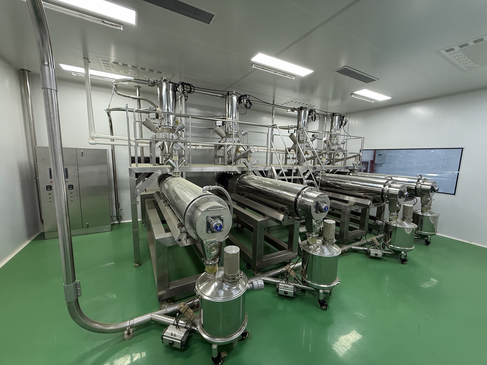 Stainless steel equipment and pipework arranged across a processing room.