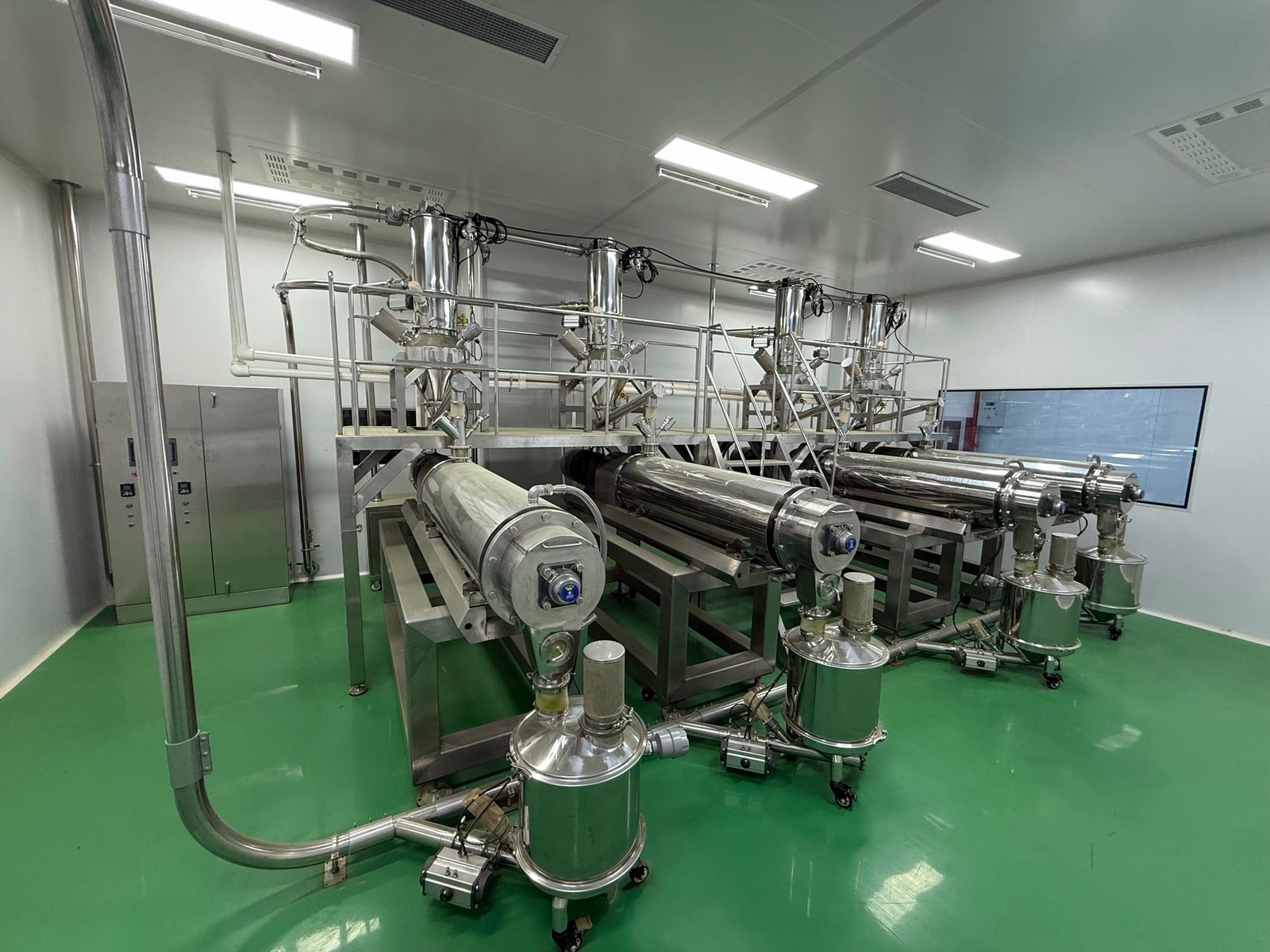 Stainless steel equipment and pipework arranged across a processing room.